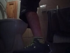 Sporty guy peeing at home